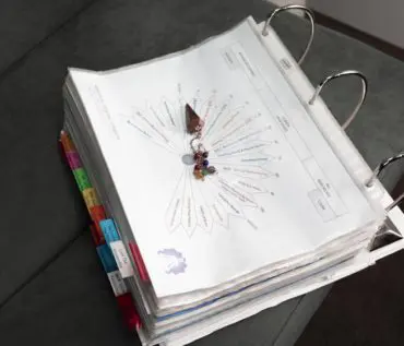 A binder with many different colored tabs on it.