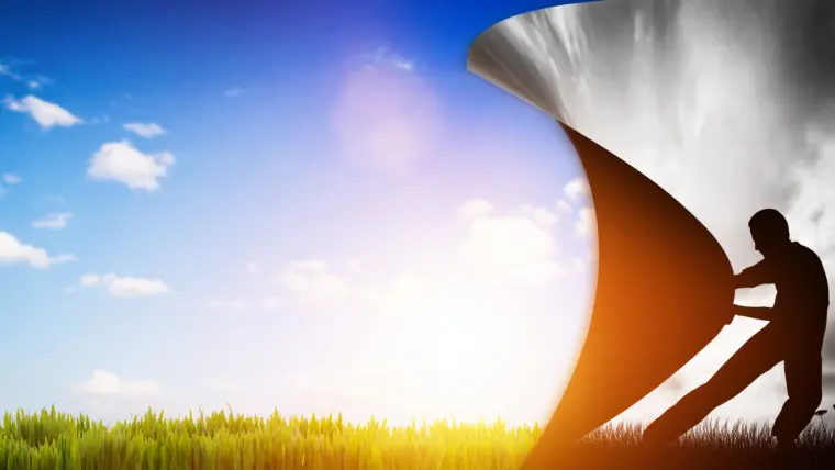 Person changing gray sky to sunny landscape.