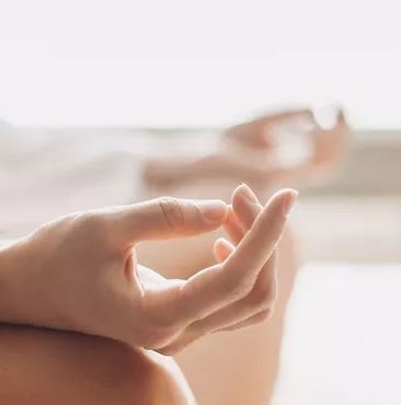 Hands of an individual who is meditating