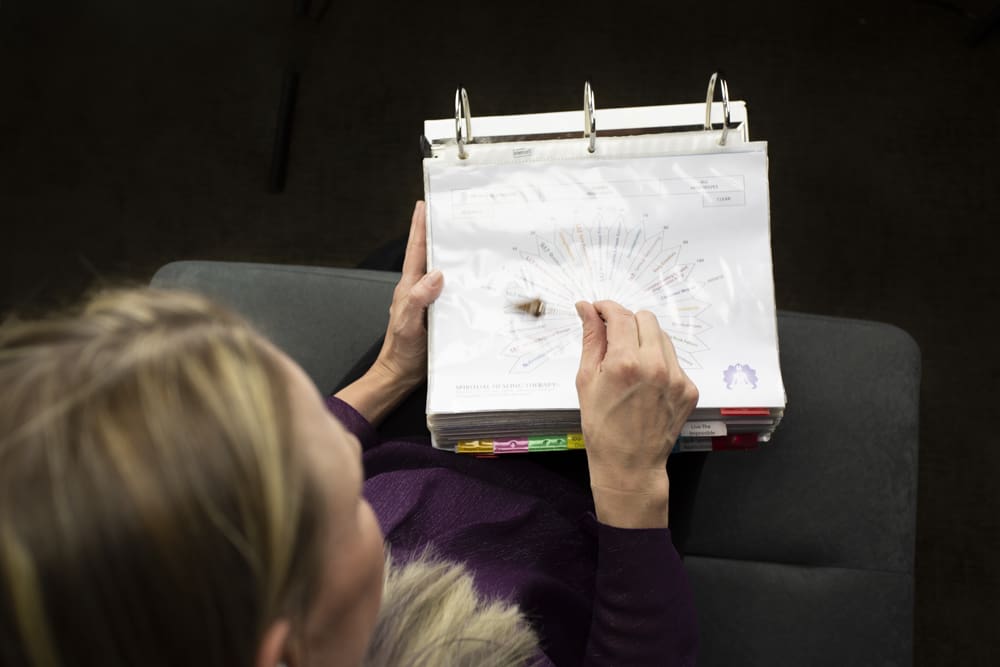 A woman holding a thick binder